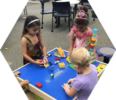 Three small children at Lego table